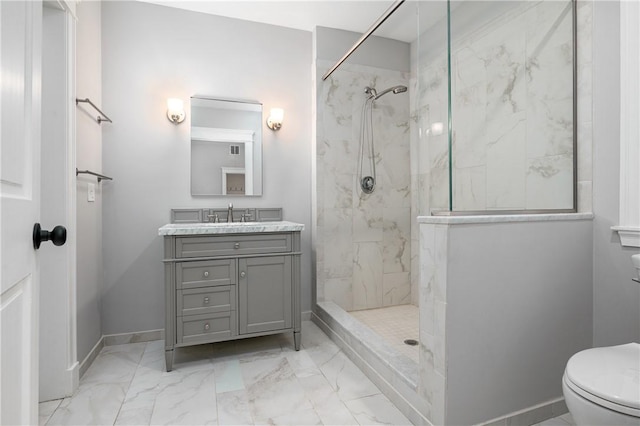 bathroom with vanity, toilet, and a tile shower