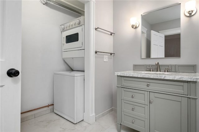 bathroom with vanity and stacked washer / drying machine