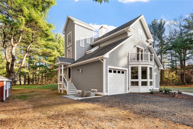 view of property exterior with a balcony and a garage