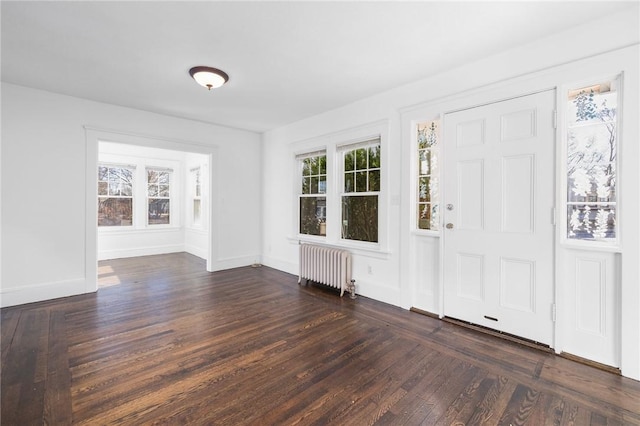 foyer featuring dark hardwood / wood-style flooring and radiator heating unit