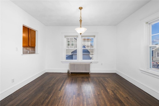 unfurnished dining area with radiator and dark hardwood / wood-style floors