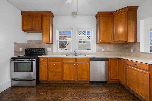 kitchen featuring dishwasher, dark wood-type flooring, sink, and black / electric stove