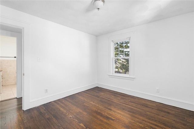 spare room featuring dark wood-type flooring