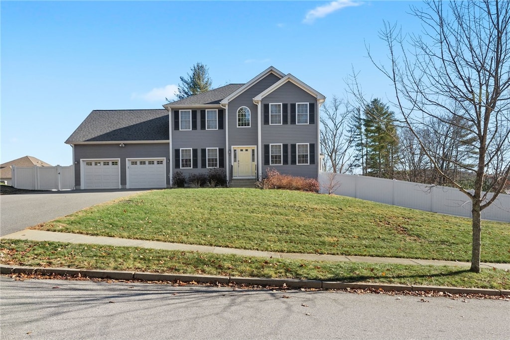 view of front facade featuring a garage and a front lawn