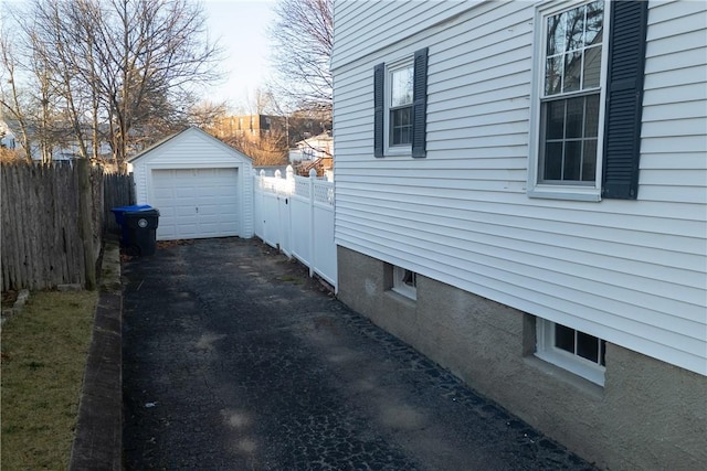 view of property exterior with an outbuilding and a garage