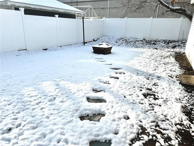 snowy yard with a fire pit