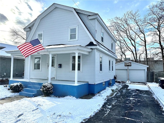 view of front of house featuring covered porch, a garage, and an outbuilding