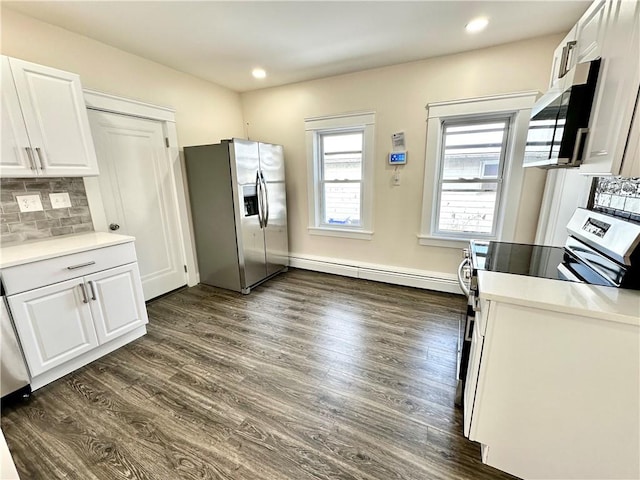 kitchen featuring decorative backsplash, stainless steel refrigerator with ice dispenser, stove, baseboard heating, and white cabinetry