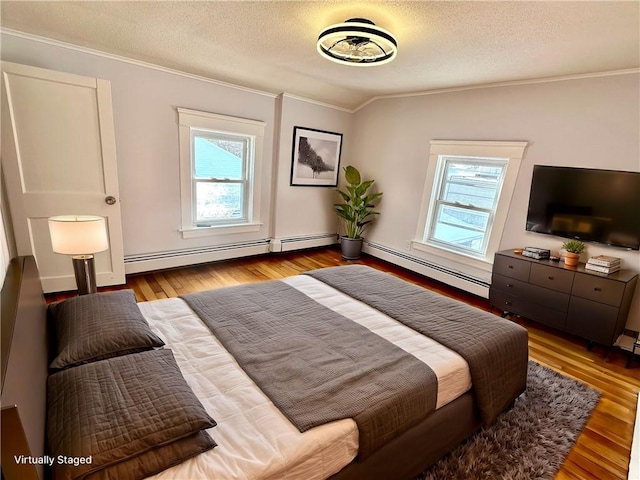 bedroom with baseboard heating, multiple windows, crown molding, and lofted ceiling