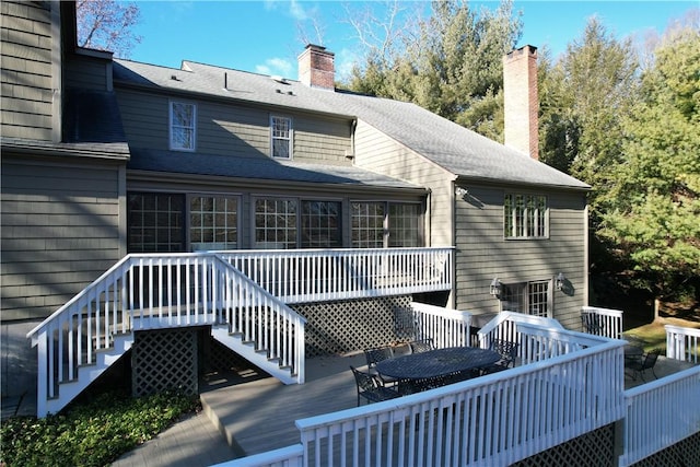 rear view of house featuring a wooden deck