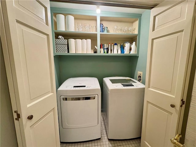 laundry room featuring light tile patterned flooring and washing machine and dryer