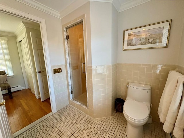 bathroom featuring tile patterned floors, toilet, a shower with shower door, and tile walls