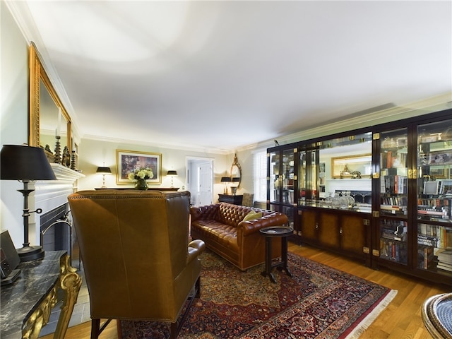 living room with wood-type flooring and ornamental molding