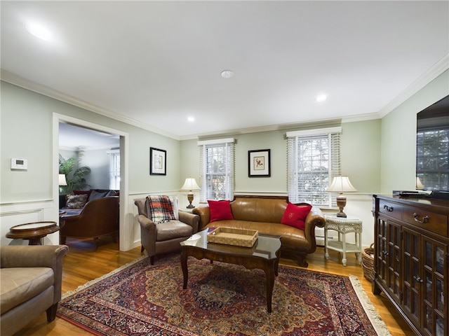 living room with light hardwood / wood-style flooring and crown molding