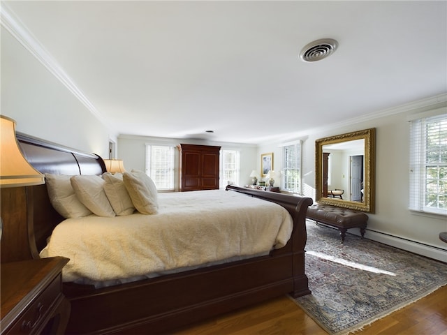 bedroom with crown molding and hardwood / wood-style flooring