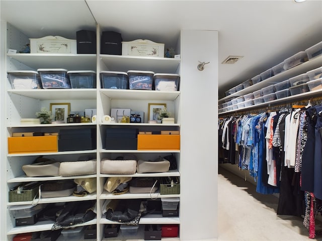 walk in closet with carpet flooring