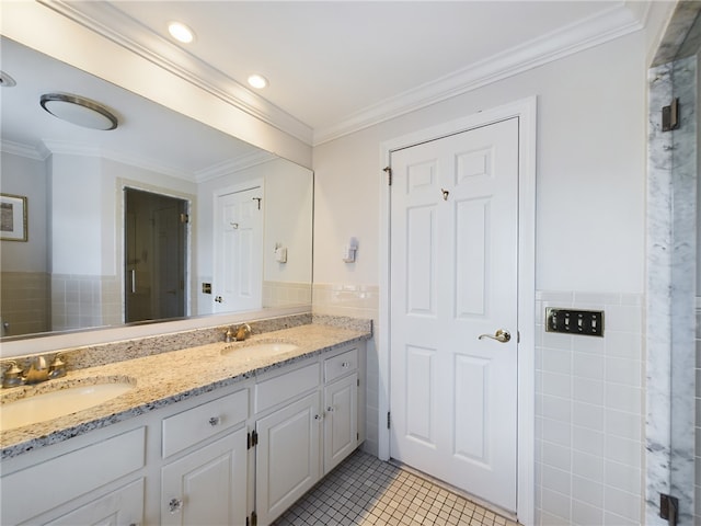 bathroom with tile patterned flooring, vanity, tile walls, and crown molding