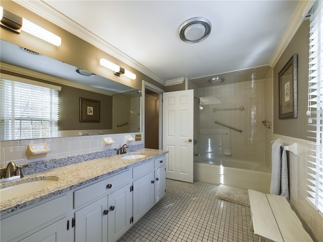 bathroom with vanity, tile patterned flooring, tiled shower / bath combo, ornamental molding, and tasteful backsplash