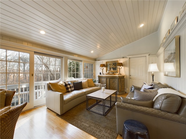 living room with light hardwood / wood-style floors, lofted ceiling, and wood ceiling