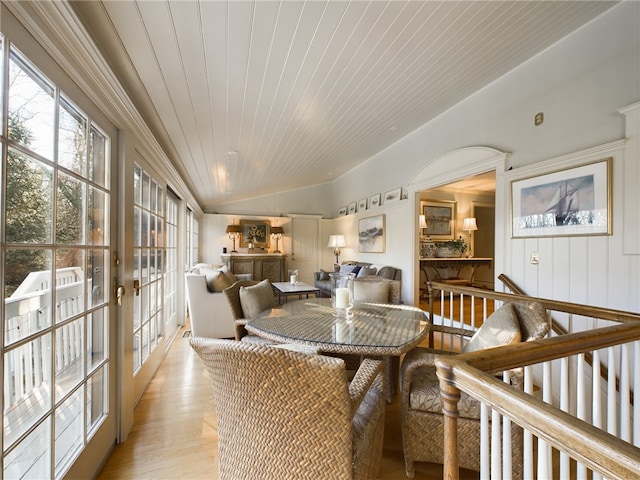 dining area featuring lofted ceiling, light wood-type flooring, and wood ceiling