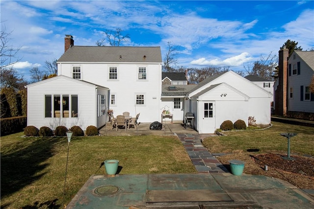 rear view of house with a patio area and a yard