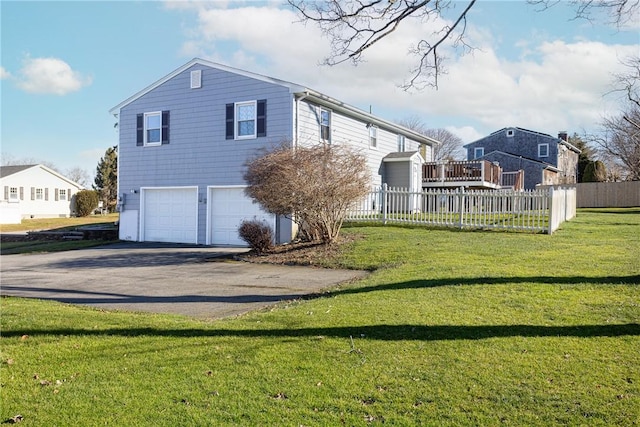 rear view of house with a yard and a garage