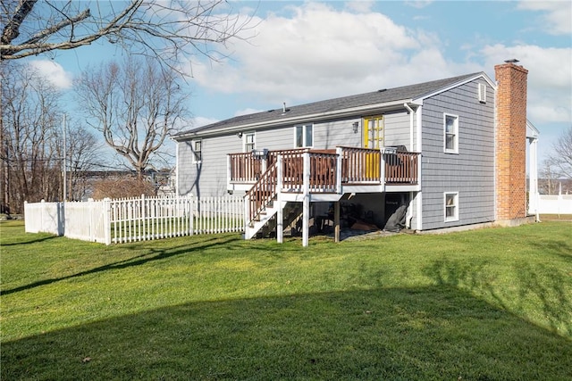 back of property featuring a lawn and a wooden deck