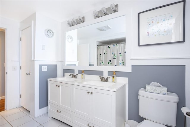 bathroom featuring walk in shower, tile patterned flooring, vanity, and toilet