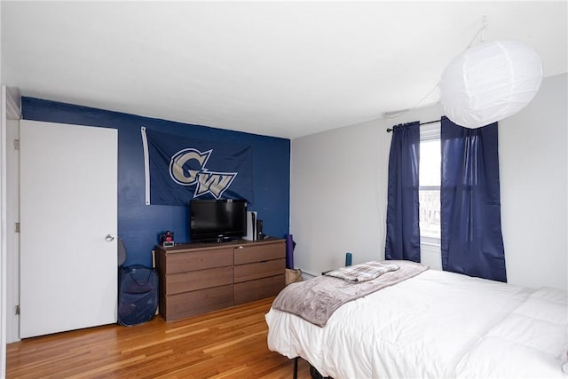 bedroom with hardwood / wood-style flooring