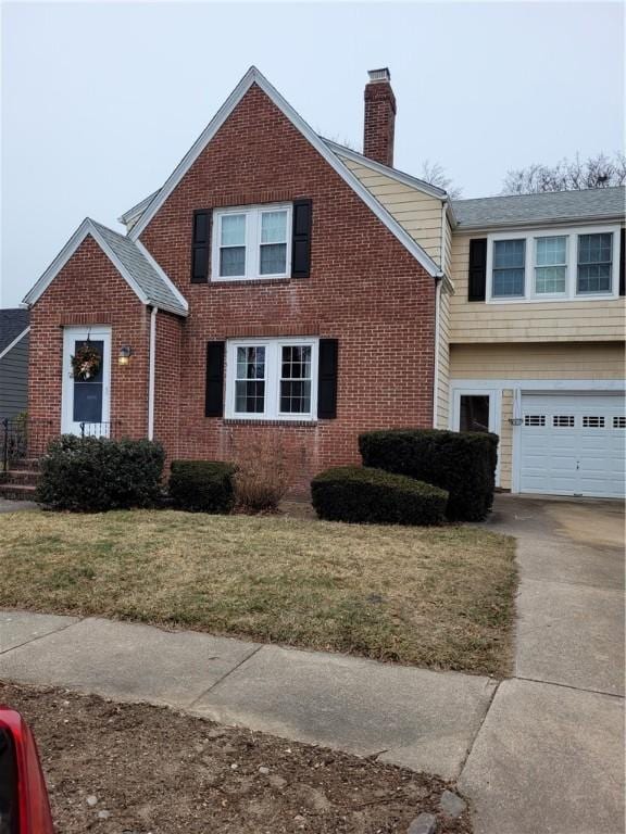 view of front facade with a front yard and a garage