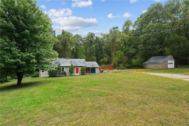 view of front of home with an outdoor structure and a front yard