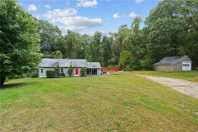 view of front of house with an outbuilding and a front yard