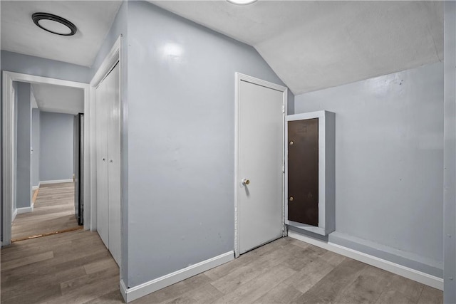 interior space featuring light hardwood / wood-style floors and vaulted ceiling