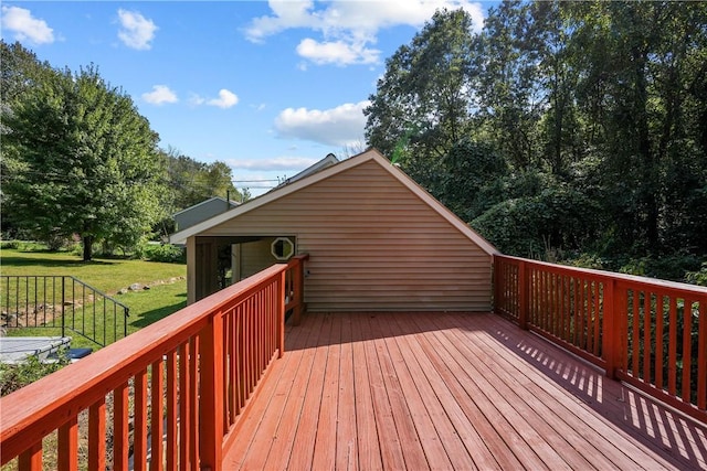 wooden terrace featuring a lawn