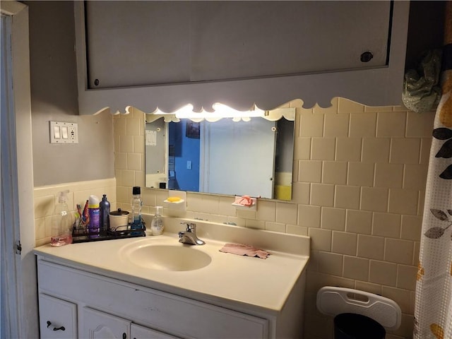 bathroom with backsplash, vanity, and tile walls