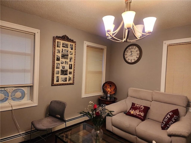 living room featuring a textured ceiling, a baseboard radiator, and a chandelier