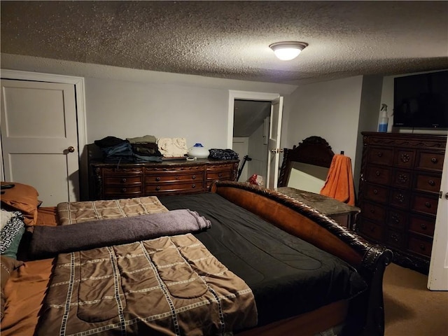 bedroom featuring carpet floors and a textured ceiling