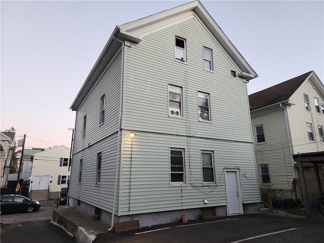 view of back house at dusk