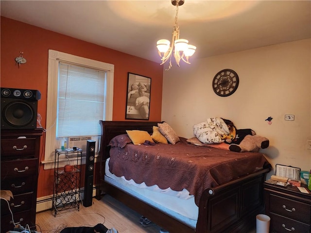 bedroom featuring cooling unit, a chandelier, and a baseboard heating unit