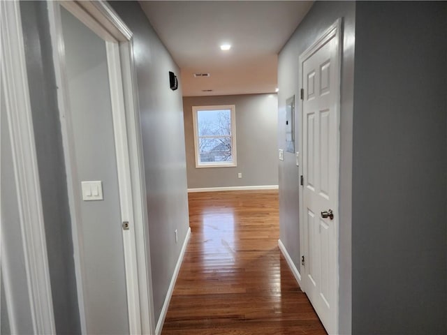 hallway with hardwood / wood-style floors