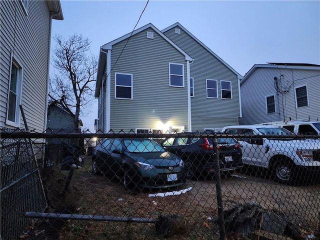 view of back house at dusk