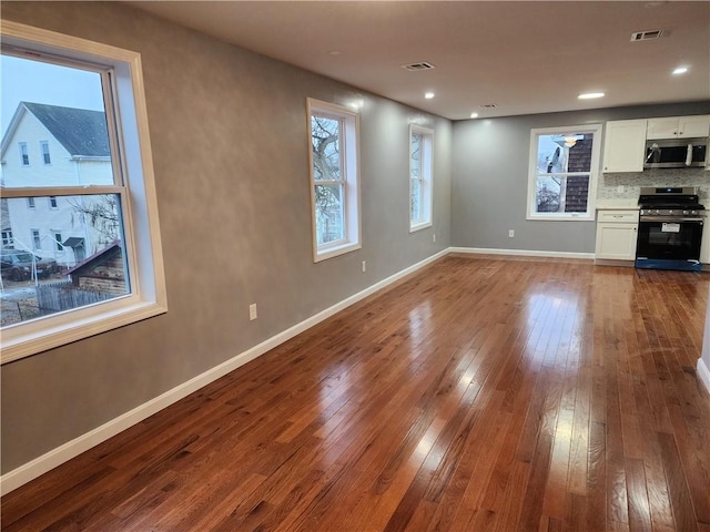 unfurnished living room with hardwood / wood-style flooring