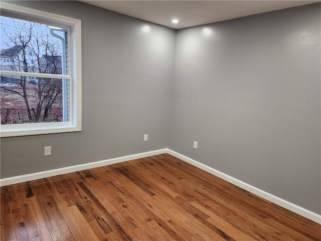 unfurnished room featuring hardwood / wood-style flooring