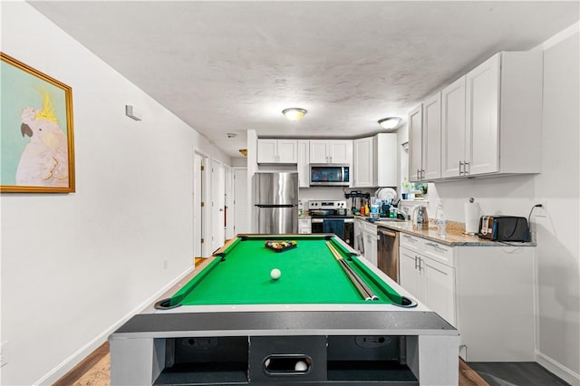 rec room featuring hardwood / wood-style floors, a textured ceiling, and pool table