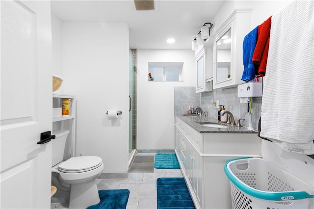 bathroom with tasteful backsplash, vanity, a shower, tile patterned flooring, and toilet