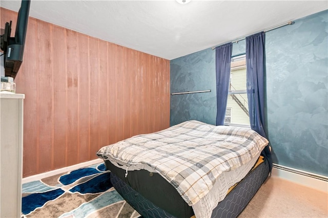 bedroom with carpet floors and wooden walls