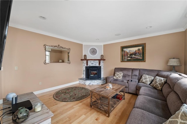 living room featuring hardwood / wood-style floors, a wood stove, and ornamental molding