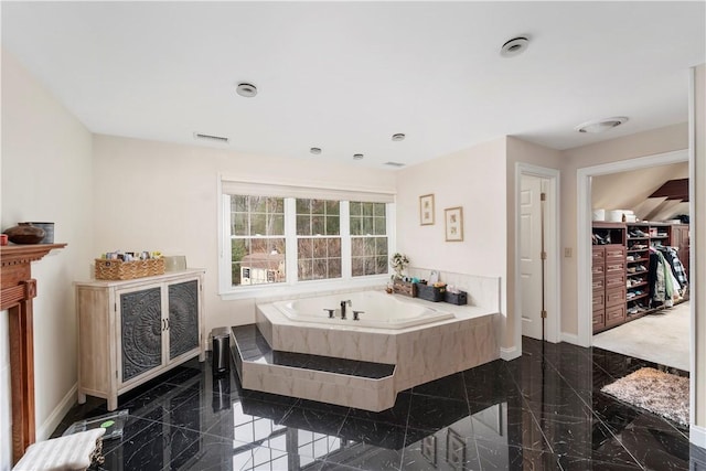 bathroom with a relaxing tiled tub