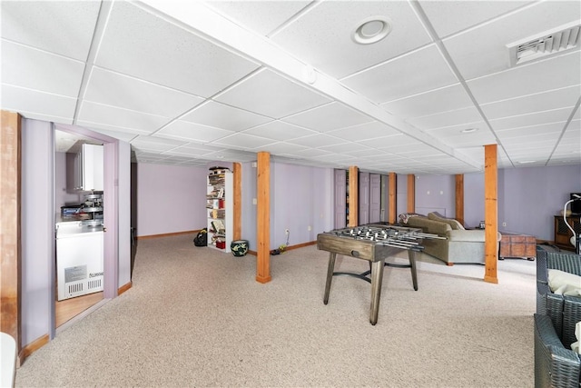 recreation room featuring a paneled ceiling and carpet