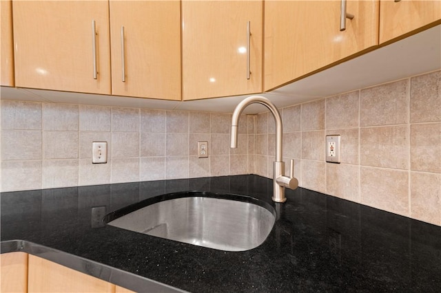 interior details with backsplash, light brown cabinets, and sink